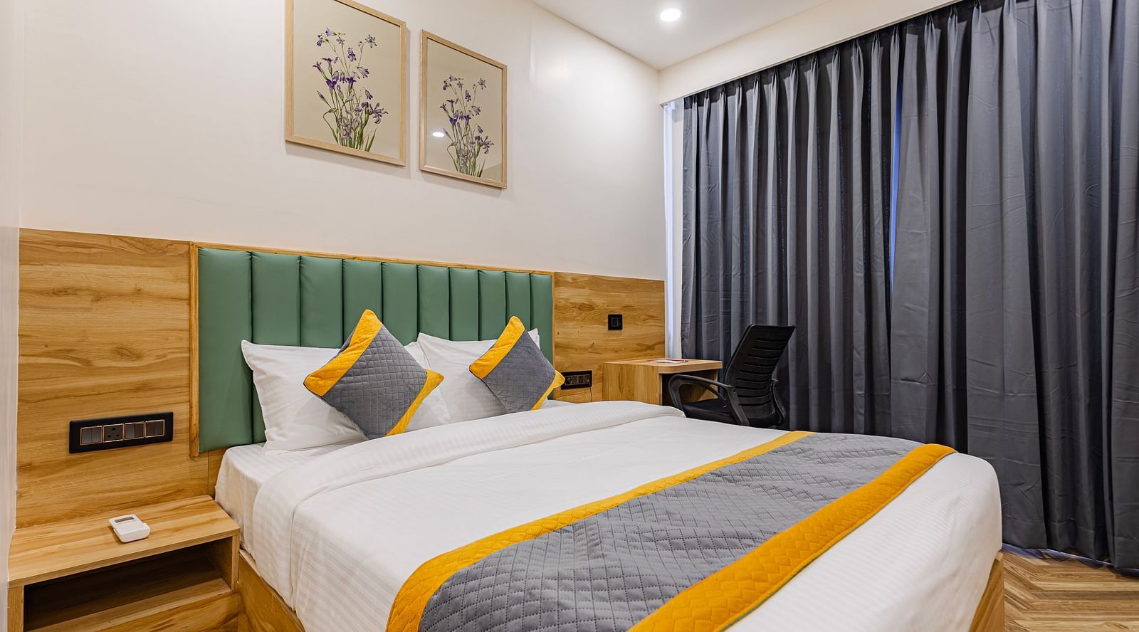 Lemonridge Hotels, KPHB | Hotel room with a bed, side tables, and a window with curtains. Comfortable and simple furnishings.